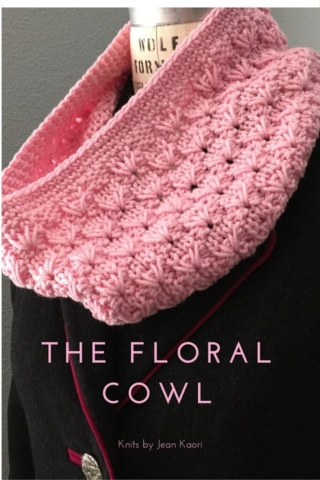 Handknit cowl in a floral stitch pattern in pink