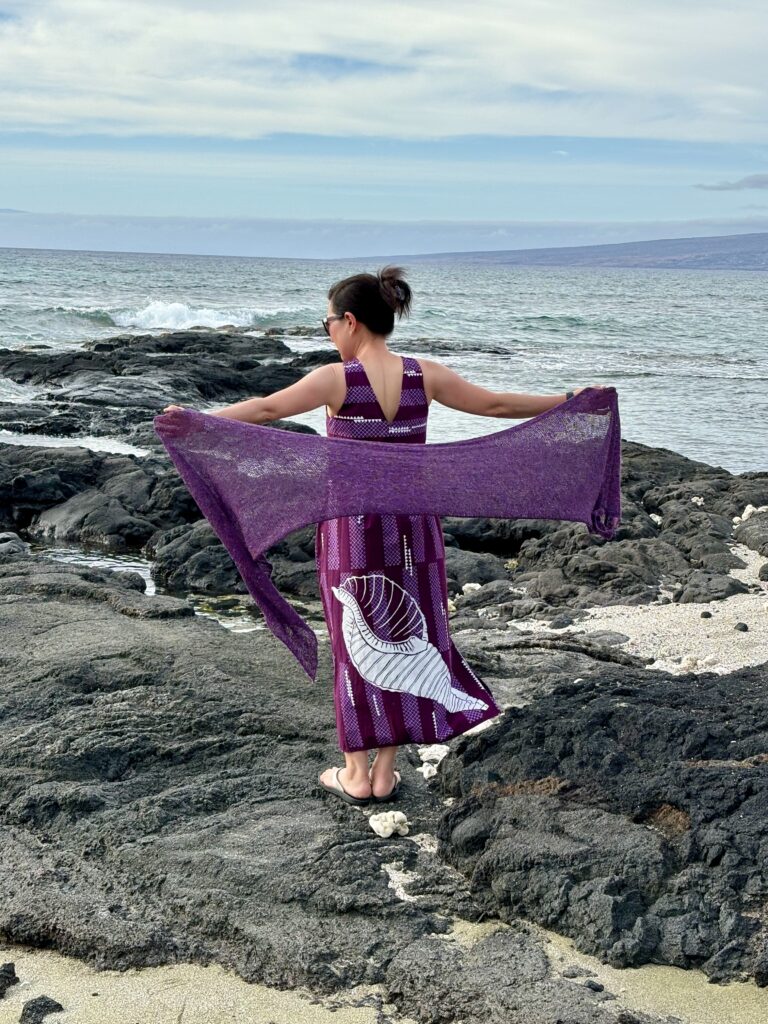 Handknit silk, cashmere, and wool wrap at a Hawaiian beach