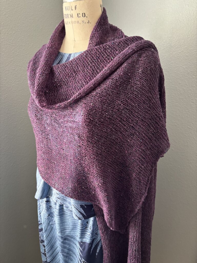 Handknit silk, cashmere, and wool wrap draped