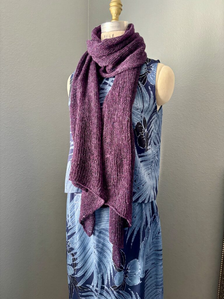 Handknit silk, cashmere, and wool wrap tied as a scarf