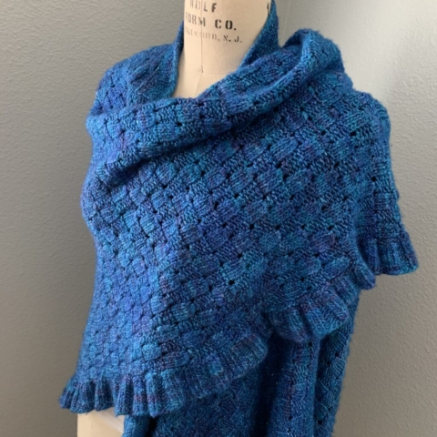 Handknit oversized wrap with ruffled edge