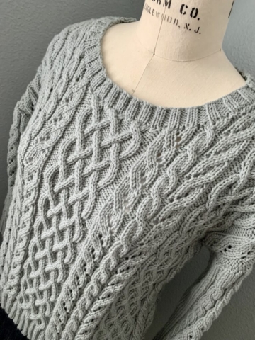 Richly cabled sweater with a wide neckline