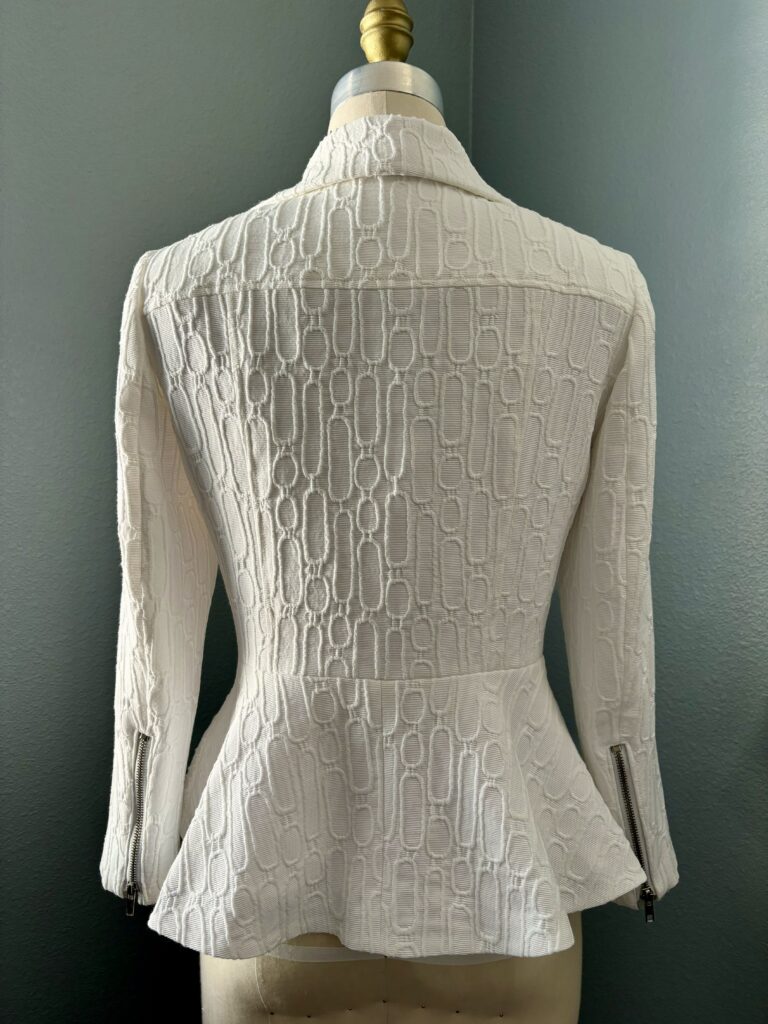 White peplum moto jacket handmade in textured fabric; back view